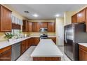 Well-lit kitchen featuring wood cabinets, stainless steel appliances, and a large island at 1517 E Elaine Dr, Casa Grande, AZ 85122