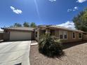 Attractive one-story home with a tile roof, desert landscaping, and a driveway at 16010 N 170Th Ln, Surprise, AZ 85388