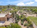 Desert home with inviting stone patio and tranquil desert landscaping at 1607 N Quartz Valley Rd, Scottsdale, AZ 85266