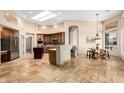 Open-concept kitchen featuring a center island, breakfast nook, and stainless steel appliances at 16211 S 4Th St, Phoenix, AZ 85048