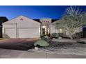 Exterior elevation of a one-story house with a three-car garage and desert landscaping at 16304 E Crystal Ridge Dr, Fountain Hills, AZ 85268