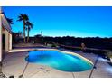 Backyard with a pool, water feature, and desert landscaping at dusk at 16304 E Crystal Ridge Dr, Fountain Hills, AZ 85268