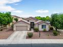 Aerial view showcasing the home's landscaped front yard and the neighborhood at 16861 W Ironwood St, Surprise, AZ 85388