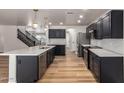 Updated kitchen boasts black cabinets, stainless appliances, light countertops, and an eat-in kitchen island at 2018 E Avenida Del Sol --, Phoenix, AZ 85024