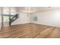 An airy living room boasting hardwood floors, contemporary lighting and staircase leading to the second floor at 2018 E Avenida Del Sol --, Phoenix, AZ 85024