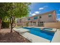 Sparkling pool featuring refreshing blue water and a serene backyard setting with mature trees and landscaping at 2018 E Avenida Del Sol --, Phoenix, AZ 85024
