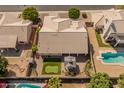 Expansive property showcasing a well-maintained house, putting green, pool, and outdoor entertaining area at 21335 N 64Th Ave, Glendale, AZ 85308