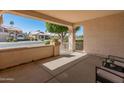 Inviting covered front porch offering a shaded seating area and a view of the well-maintained neighborhood at 21335 N 64Th Ave, Glendale, AZ 85308