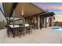 Backyard features an outdoor kitchen, covered patio, and pool for backyard fun at 24280 N 164Th Dr, Surprise, AZ 85387