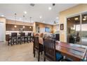 Open-concept dining area seamlessly connects to the kitchen and living room, with sliding door access to the patio at 24280 N 164Th Dr, Surprise, AZ 85387