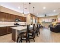 Modern kitchen with a large center island, breakfast bar, stainless steel appliances, and open access to the living area at 24280 N 164Th Dr, Surprise, AZ 85387