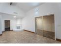 Bright living room features neutral paint, tile flooring, fireplace, and sliding glass doors at 2445 W Yuma St, Phoenix, AZ 85009
