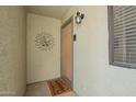 Inviting front entrance with welcome mat and decorative sunburst design at 2524 S El Paradiso -- # 122, Mesa, AZ 85202
