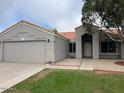Charming single-story home with a well-maintained front yard and neutral-colored exterior at 2649 N 85Th Ave, Phoenix, AZ 85037