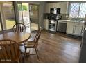 Eat-in kitchen with stainless steel appliances, white cabinets, and access to the backyard at 2649 N 85Th Ave, Phoenix, AZ 85037