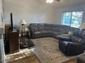 Spacious living room with a large sectional sofa, comfortable seating, and a window for natural light at 2649 N 85Th Ave, Phoenix, AZ 85037