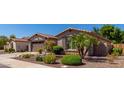 Beautiful home featuring desert landscaping, a palm tree, and a two-car garage at 2680 E Lodgepole Dr, Gilbert, AZ 85298