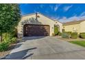 Attractive single-story home showcasing a lush front yard and classic architectural design with a two-car garage at 3566 S Colorado St, Chandler, AZ 85286
