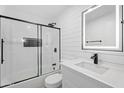 Modern bathroom features a walk-in shower, sleek vanity, and an illuminated mirror at 3646 N 69Th Ave # 55, Phoenix, AZ 85033