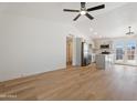 Open-concept living room and kitchen feature hardwood floors and recessed lighting at 3646 N 69Th Ave # 55, Phoenix, AZ 85033