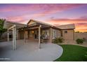 The back exterior features a covered patio with outdoor furniture and a well-manicured lawn at 4020 N 151St Dr, Goodyear, AZ 85395