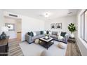 Bright living room featuring a large sectional sofa, stylish decor, and ample natural light at 4153 W Sunnyside Ave, Phoenix, AZ 85029