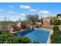 Beautiful pool and yard with a fountain, outdoor bar, and desert views at 41910 N Long Cove Way, Anthem, AZ 85086