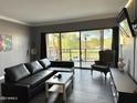 Inviting living room features a sliding glass door with scenic outdoor views and modern furnishings at 4750 N Central Ave # M2, Phoenix, AZ 85012