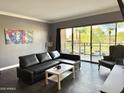 Inviting living room features a sliding glass door with scenic outdoor views and modern furnishings at 4750 N Central Ave # M2, Phoenix, AZ 85012
