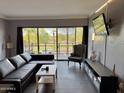 Inviting living room features a sliding glass door with scenic outdoor views and modern furnishings at 4750 N Central Ave # M2, Phoenix, AZ 85012