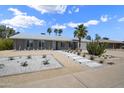Charming single-story home featuring desert landscaping with a rock lawn, walkway, and large cactus at 4904 E Tierra Buena Ln, Scottsdale, AZ 85254