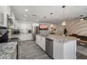 Bright, modern kitchen with white cabinets, a large island, stainless appliances, and wood-look tile at 4904 E Tierra Buena Ln, Scottsdale, AZ 85254