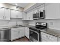 Updated kitchen featuring white cabinets, granite countertops, stainless steel appliances and subway tile backsplash at 6007 N 79Th St, Scottsdale, AZ 85250