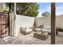 Outdoor patio with modern seating, a brick-paved floor, and a stylish coffee table with refreshments at 6007 N 79Th St, Scottsdale, AZ 85250