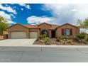 Charming single-story home featuring a well-manicured front yard and an attached two-car garage at 6125 E Hodges St, Cave Creek, AZ 85331
