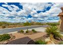 Manicured front yard featuring desert landscaping and a charming stone path to the property at 6125 E Hodges St, Cave Creek, AZ 85331