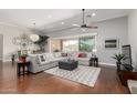 Bright living room with hardwood floors, large sectional sofa, and sliding glass doors to the backyard at 6125 E Hodges St, Cave Creek, AZ 85331