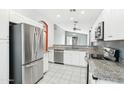 Bright kitchen featuring stainless steel appliances, granite countertops, and white cabinetry at 6777 W Tether Trl, Peoria, AZ 85383