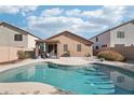 Backyard pool offers a relaxing outdoor experience with a covered patio seating area at 6777 W Tether Trl, Peoria, AZ 85383