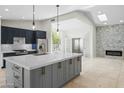 Gourmet kitchen with a large island, quartz countertops and stainless steel appliances at 6920 W Via Montoya Dr, Glendale, AZ 85310
