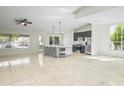 Open concept living area adjacent to the kitchen and features tile flooring and plenty of natural light at 6920 W Via Montoya Dr, Glendale, AZ 85310