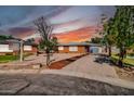 Inviting brick home features desert landscaping, mature trees, and a convenient driveway at 7039 N 15Th St, Phoenix, AZ 85020