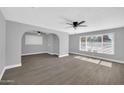 Open living room features contemporary gray walls, light floors, and large windows at 7039 N 15Th St, Phoenix, AZ 85020