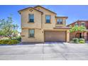 Two-story home featuring a two-car garage, stucco siding and a well maintained lawn at 7412 E Flower Ave, Mesa, AZ 85208