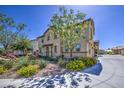 Two story home with manicured landscaping that includes flower beds and mature trees at 7412 E Flower Ave, Mesa, AZ 85208