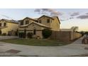 Two-story home with green lawn, desert landscaping, and privacy wall at 8221 W Hess Ave, Phoenix, AZ 85043