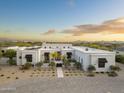 Stunning modern home featuring desert landscaping, a grand entrance, and a spacious driveway, offering curb appeal at 8245 E Via Del Sol Dr, Scottsdale, AZ 85255
