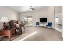 Inviting living room with a ceiling fan, neutral colors, and sliding glass doors to the patio at 8576 E Jasper St, Gold Canyon, AZ 85118