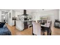 Bright, open kitchen boasts modern white cabinets, stainless steel appliances, and a functional island at 8631 E Jackrabbit Rd, Scottsdale, AZ 85250