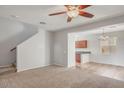 Open living room with ceiling fan, tile and carpet flooring and view to bar area at 935 E Redondo Dr, Gilbert, AZ 85296
